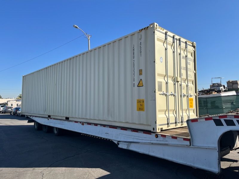Container being delivered on a tilt bed trailer